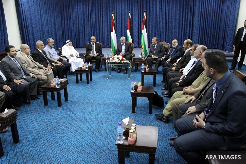 The members of the Muslim Brotherhood, Ezz El-Deen Al-Hussini and Hazem Farouk sit next to Palestinian prime minister in Gaza Strip, Ismail Hanyia at his office in Gaza city on June 12,2011 during the visiting of Muslim...