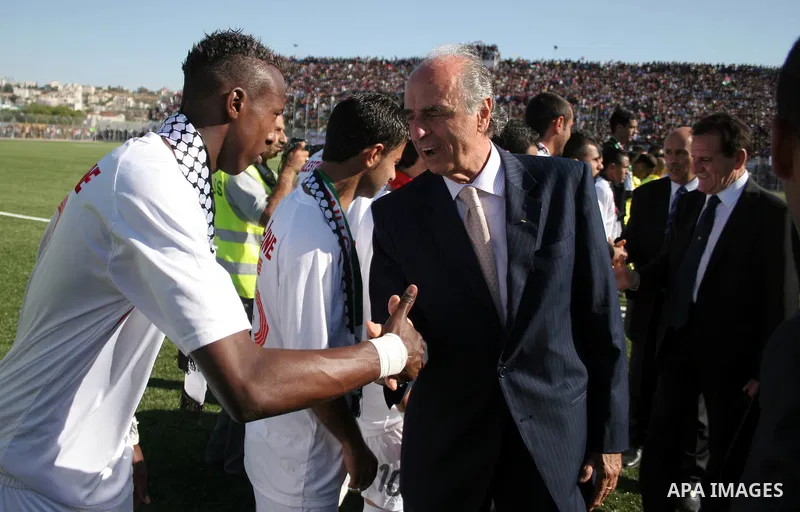 Members of the Italian delegation shake hand with Palestinian players during a friendly football match between the Palestinian and Italian Olympic teams to mark the inauguration of the Dura Stadium near the West Bank cit...