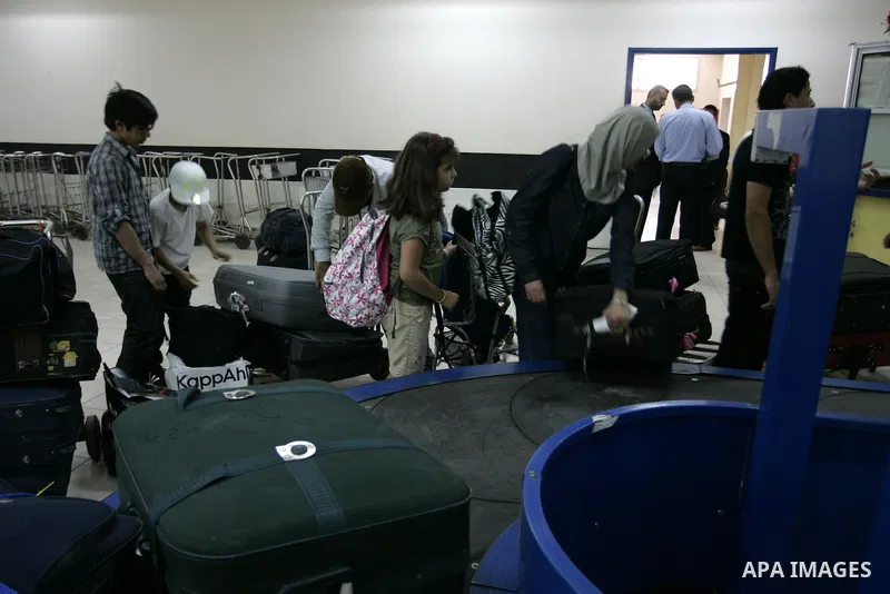 Palestinians load their luggage coming from Egypt through the Rafah border crossing in the southern Gaza Strip on on June 13, 2011. Photo by Abed Rahim Khatib