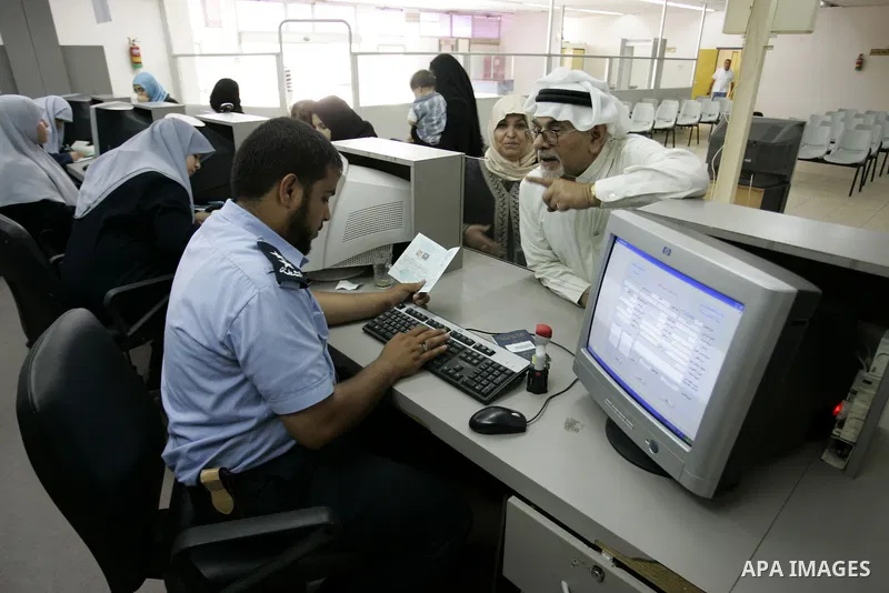 Palestinian Hamas border police check identity documents of travellers crossing into Egypt through the Rafah border crossing in the southern Gaza Strip on on June 12, 2011. Photo by Abed Rahim Khatib