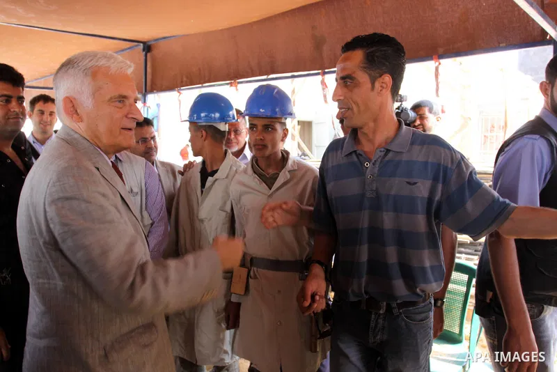European Parliament President Jerzy Buzek (C) visits a UN aid center in al-Shati refugee camp in Gaza City on June 13, 2011. Photo by Mohammed Asad