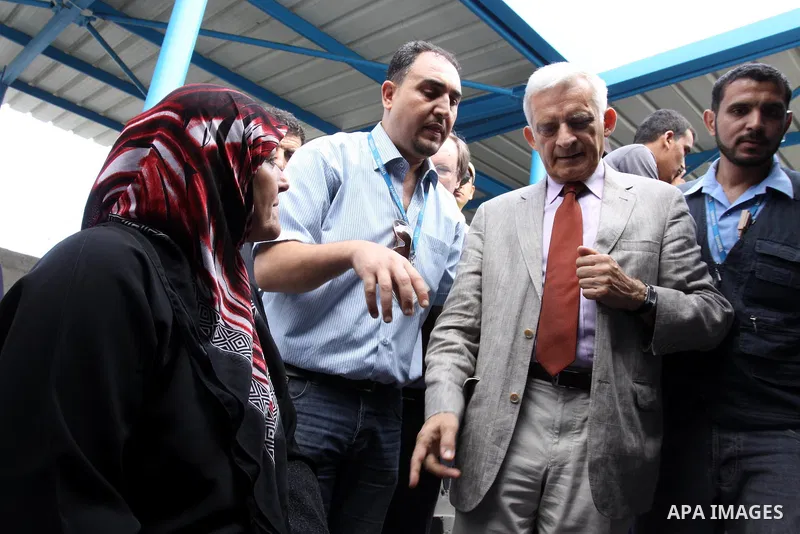 European Parliament President Jerzy Buzek speaks to a Palestinian woman during his visit to Deaf Center in Gaza City on June 13, 2011. Photo by Mohammed Asad
