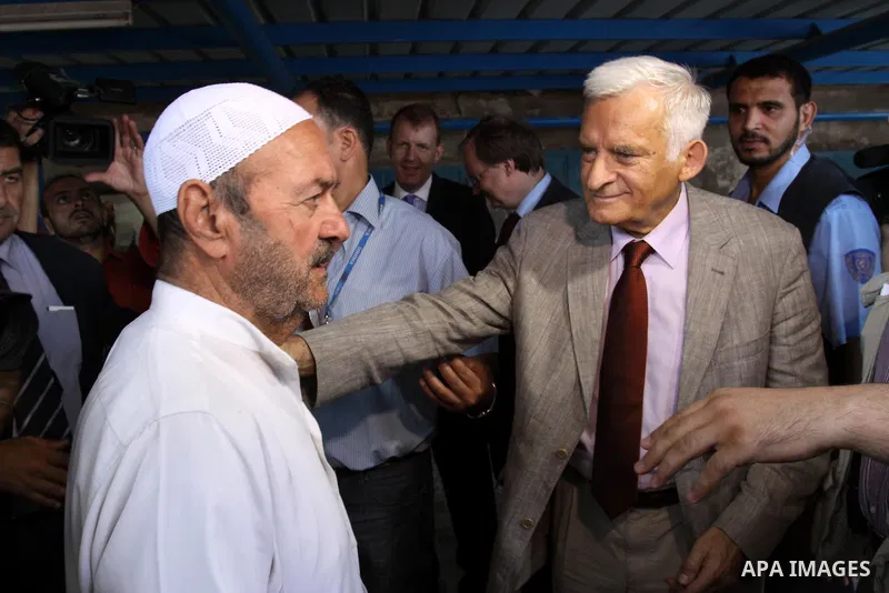 European Parliament President Jerzy Buzek speaks to a Palestinian man during his visit to Deaf Center in Gaza City on June 13, 2011. Photo by Mohammed Asad