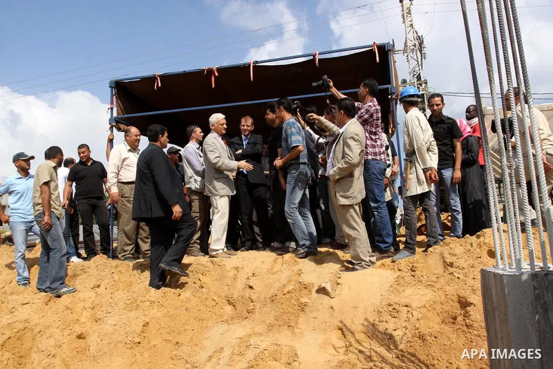 European Parliament President Jerzy Buzek (C) visits a UN aid center in al-Shati refugee camp in Gaza City on June 13, 2011. Photo by Mohammed Asad