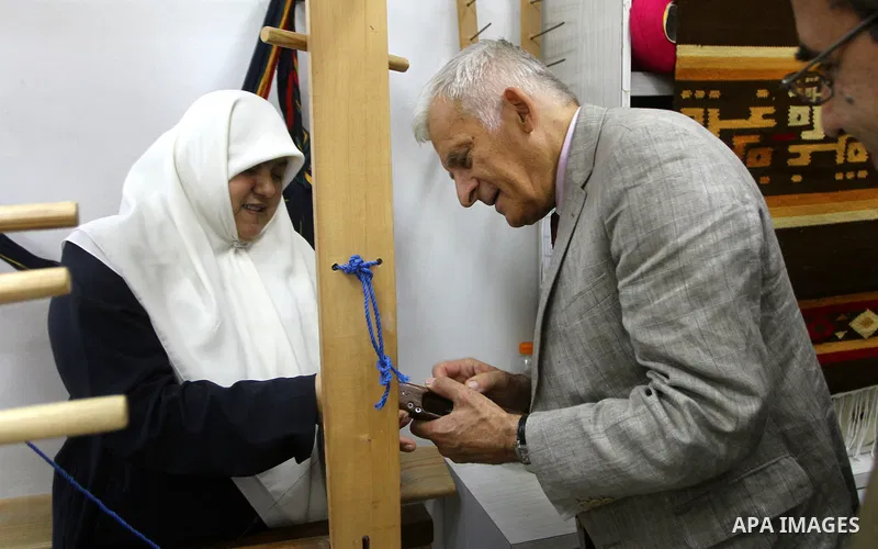 European Parliament President Jerzy Buzek speaks to a Palestinian woman during his visit to Deaf Center in Gaza City on June 13, 2011. Photo/Ashraf Amra- POOL