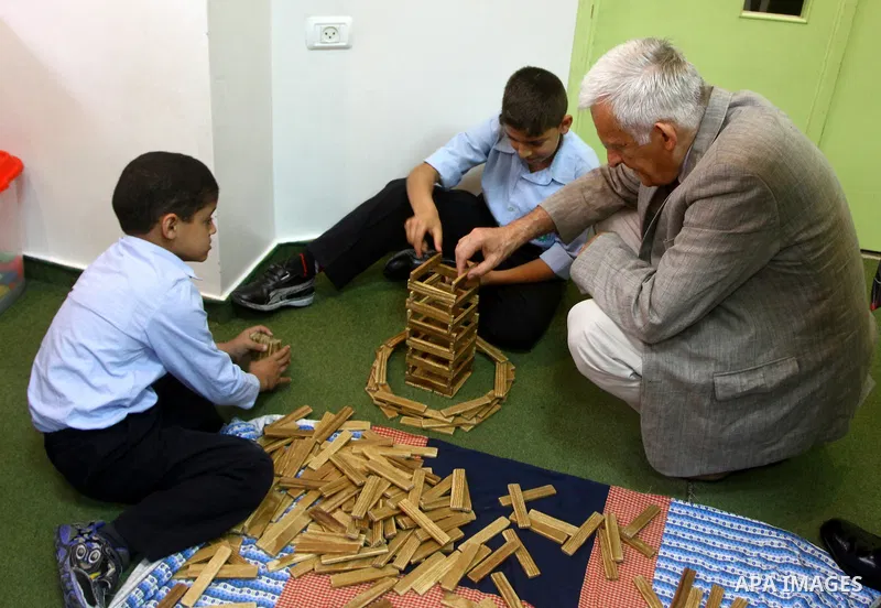 European Parliament President Jerzy Buzek meets Palestinian children during his visit to Deaf Center in Gaza City on June 13, 2011. Photo/Ashraf Amra- POOL