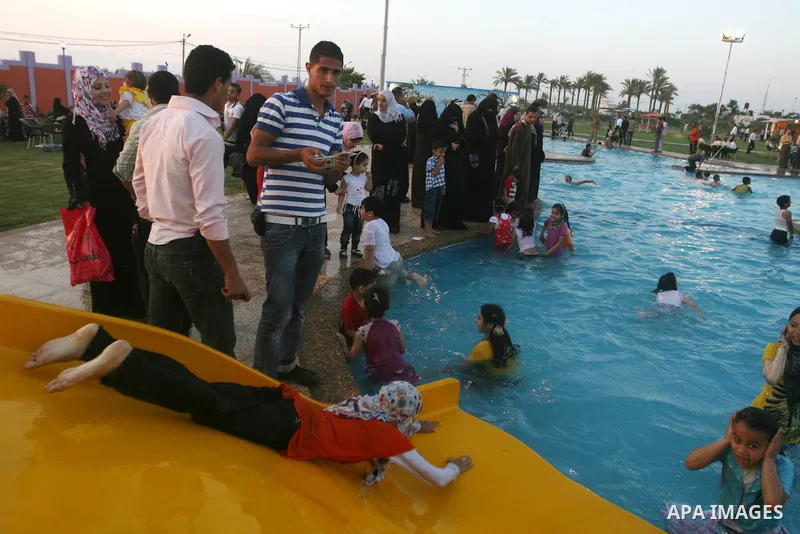 Palestinians enjoy swimming in a pool at the newly-opened "Asda City" touristic resort in Khan Yunis, south of the Gaza Strip, on June 14, 2011. Photo by Majdi Fathi