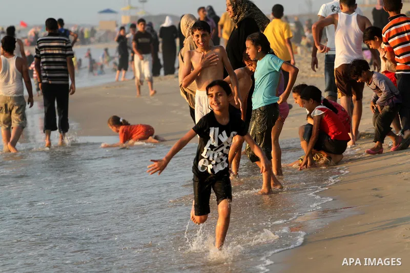 Palestinians enjoy swimming at the beach in Gaza city on June 14, 2011. Photo by Mohammed Asad