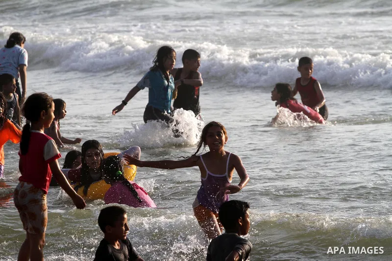 Palestinians enjoy swimming at the beach in Gaza city on June 14, 2011. Photo by Mohammed Asad