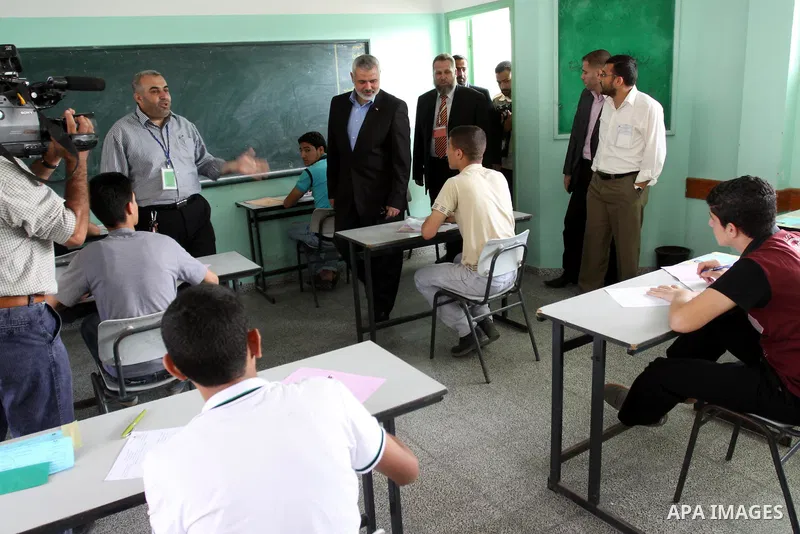 Palestinian Prime Minister in Gaza Strip, Ismail Haniya visits students as they sit for their final high school exams, known as "Tawjihi", in Gaza City on June 15, 2011. Photo by Mohammed Asad