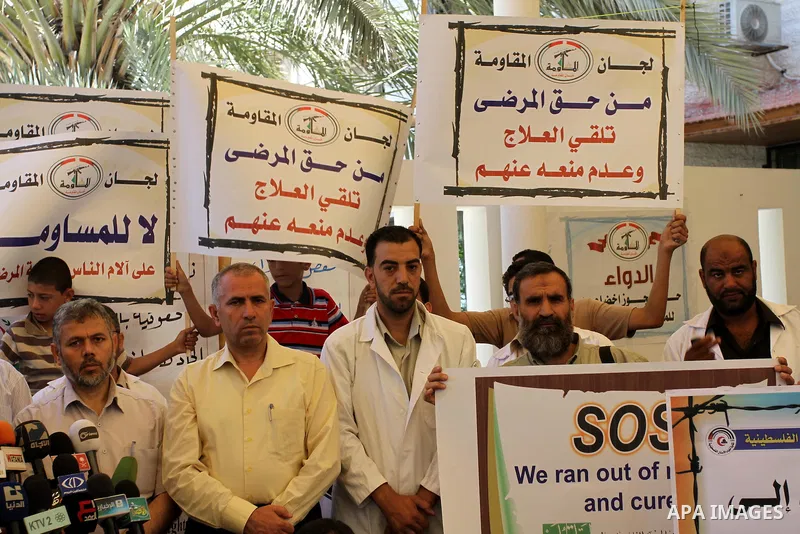 Palestinian doctors protest in the headquarters of the Red Cross calling for lifting the siege and the introduction of medicines in Gaza city on June 15, 2011. Photo by Mohammed Asad