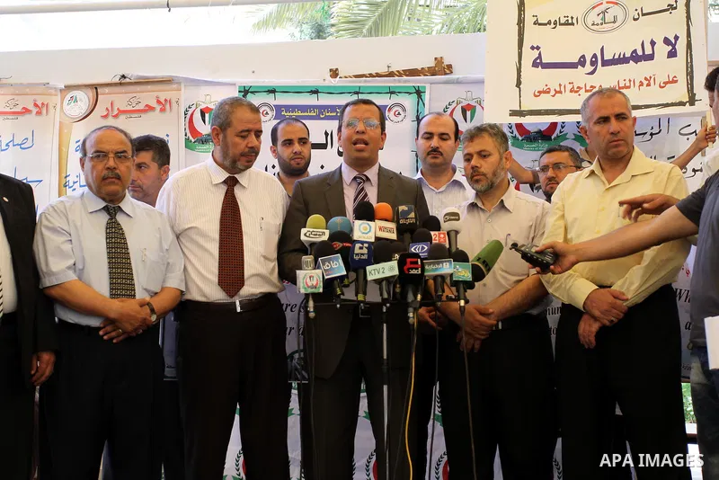 Palestinian doctors display a speech in a press conference during a protest in the headquarters of the Red Cross calling for lifting the siege and the introduction of medicines in Gaza city on June 15, 2011. Photo by Moh...