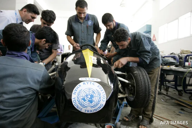 Palestinian students test their Formula 1-style racing car, made from scratch out of recycled parts, they have produced at their technical college run by the United Nations in Khan Yunis, southern Gaza Strip, on June 15,...