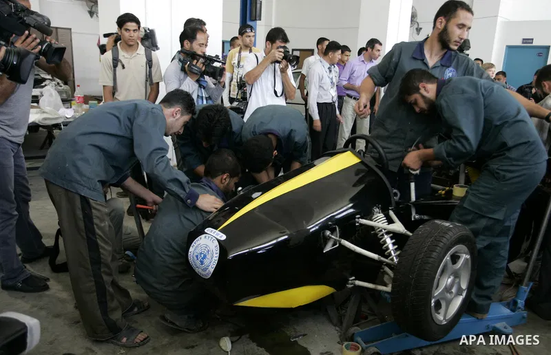 Palestinian students test their Formula 1-style racing car, made from scratch out of recycled parts, they have produced at their technical college run by the United Nations in Khan Yunis, southern Gaza Strip, on June 15,...