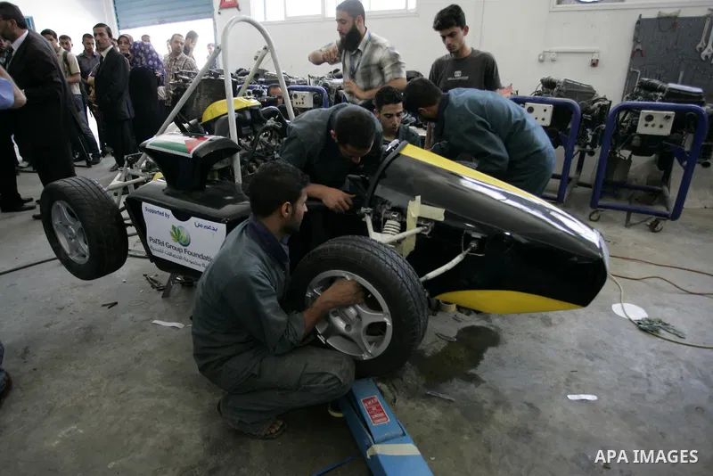 Palestinian students test their Formula 1-style racing car, made from scratch out of recycled parts, they have produced at their technical college run by the United Nations in Khan Yunis, southern Gaza Strip, on June 15,...