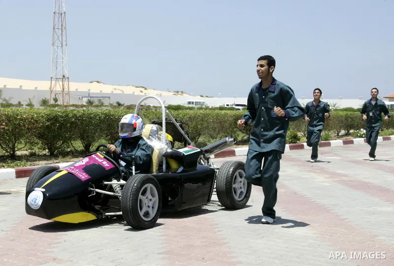 Palestinian students test their Formula 1-style racing car, made from scratch out of recycled parts, they have produced at their technical college run by the United Nations in Khan Yunis, southern Gaza Strip, on June 15,...