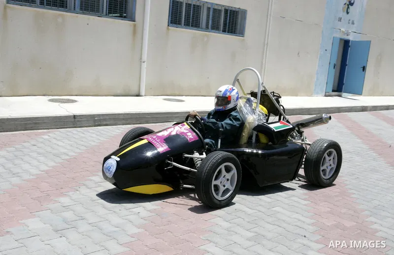 Palestinian students test their Formula 1-style racing car, made from scratch out of recycled parts, they have produced at their technical college run by the United Nations in Khan Yunis, southern Gaza Strip, on June 15,...
