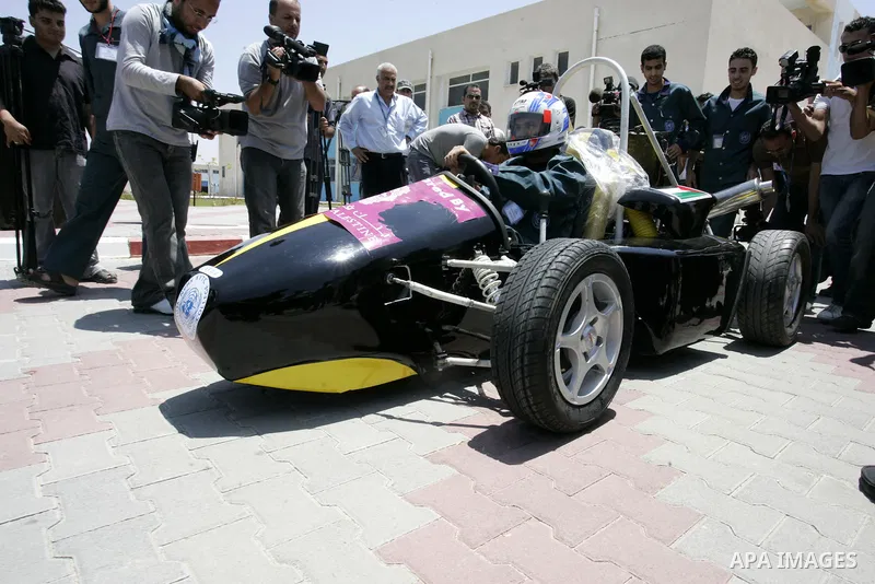 Palestinian students test their Formula 1-style racing car, made from scratch out of recycled parts, they have produced at their technical college run by the United Nations in Khan Yunis, southern Gaza Strip, on June 15,...