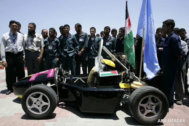 Palestinian students test their Formula 1-style racing car, made from scratch out of recycled parts, they have produced at their technical college run by the United Nations in Khan Yunis, southern Gaza Strip, on June 15,...