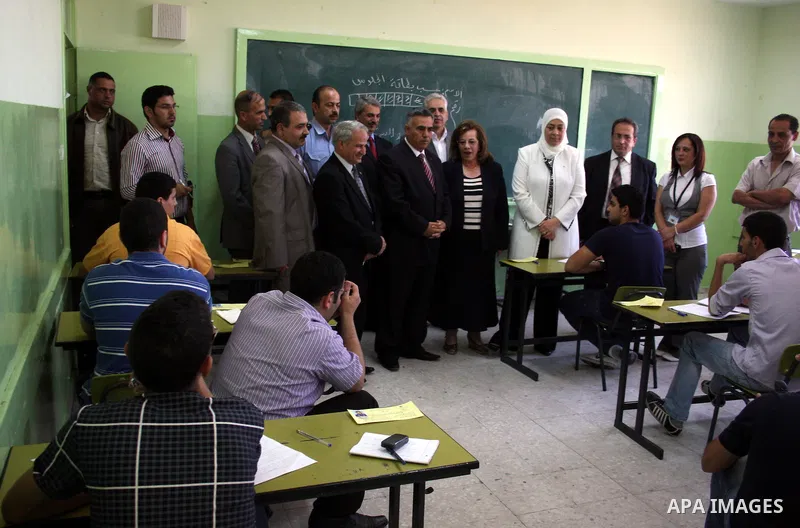 Palestinian Hussein Al-Araj, the representative of the Palestinian President Mahmoud Abbas, visits students as they sit for their final high school exams, known as "Tawjihi", in the West Bank city of Ramallah on June 15,...