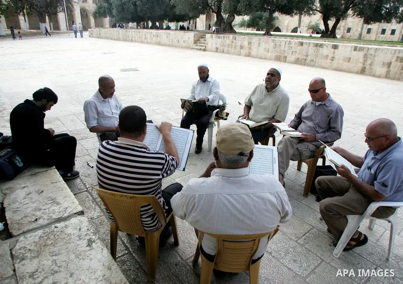Palestinian Muslim men gather to read the Holy Quran inside the Al-Aqsa Mosque compound in Jerusalem old city on Jun 15,2011. Photo by Mahfouz Abu Turk