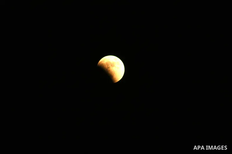 A Portion of the moon crosses into the Earth's shadow seen from Gaza city, on June 15, 2011. Astronomers in parts of Europe, Africa, Central Asia and Australia were hoping for clear skies on June 15 to enjoy a total luna...