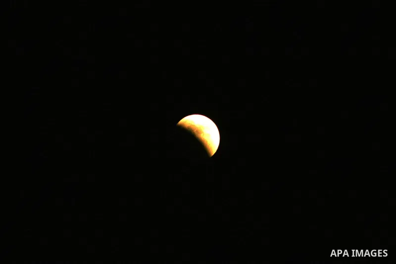 A Portion of the moon crosses into the Earth's shadow seen from Gaza city, on June 15, 2011. Astronomers in parts of Europe, Africa, Central Asia and Australia were hoping for clear skies on June 15 to enjoy a total luna...