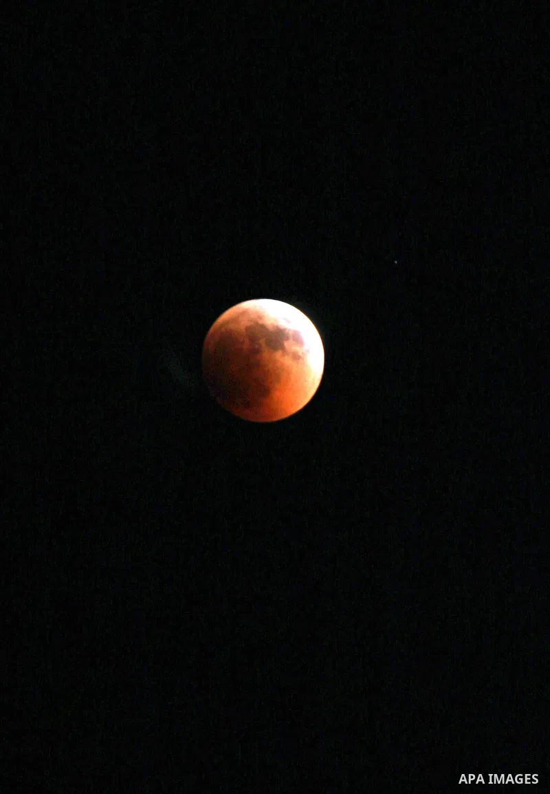 A Portion of the moon crosses into the Earth's shadow seen from the west Bank city of Nablus, on June 15, 2011. Astronomers in parts of Europe, Africa, Central Asia and Australia were hoping for clear skies on June 15 to...
