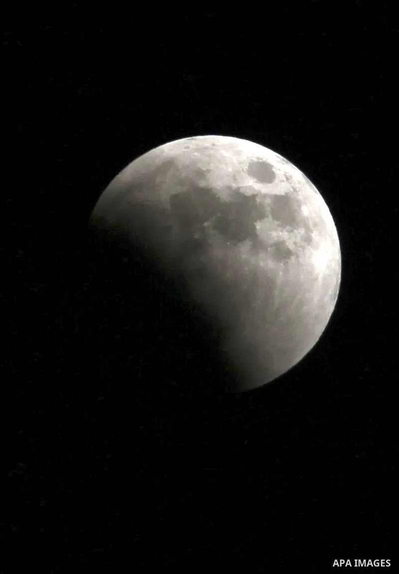 A Portion of the moon crosses into the Earth's shadow seen from the west Bank city of Nablus, on June 15, 2011. Astronomers in parts of Europe, Africa, Central Asia and Australia were hoping for clear skies on June 15 to...