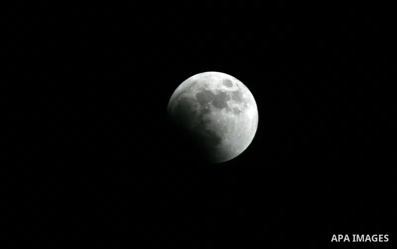 A Portion of the moon crosses into the Earth's shadow seen from Gaza Strip, Rafah City, on June 15, 2011. Astronomers in parts of Europe, Africa, Central Asia and Australia were hoping for clear skies on June 15 to enjoy...