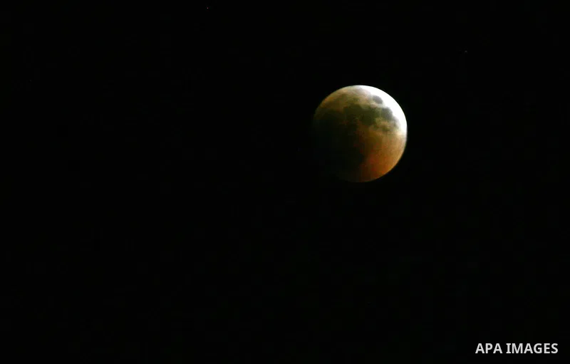 A Portion of the moon crosses into the Earth's shadow seen from Gaza Strip, Rafah City, on June 15, 2011. Astronomers in parts of Europe, Africa, Central Asia and Australia were hoping for clear skies on June 15 to enjoy...