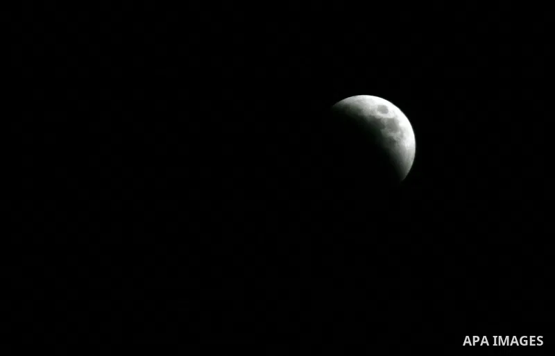 A Portion of the moon crosses into the Earth's shadow seen from Gaza Strip, Rafah City, on June 15, 2011. Astronomers in parts of Europe, Africa, Central Asia and Australia were hoping for clear skies on June 15 to enjoy...