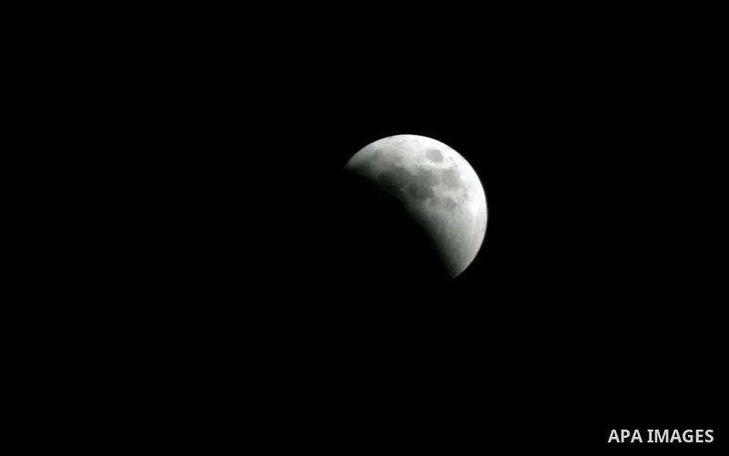 A Portion of the moon crosses into the Earth's shadow seen from Gaza Strip, Rafah City, on June 15, 2011. Astronomers in parts of Europe, Africa, Central Asia and Australia were hoping for clear skies on June 15 to enjoy...