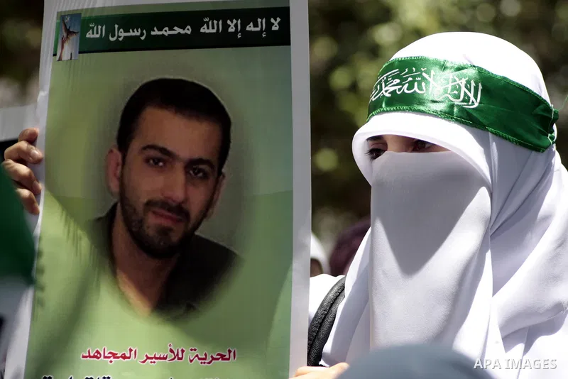 Palestinian Hamas supporters hold up pictures of relatives who were arrested and imprisoned for political reasons by Palestinian Authority security forces, during a protest in the West Bank city of Hebron, on June 16,201...