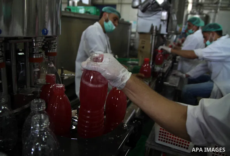 Palestinian workers bottle fruit juice at Juice Factory in Gaza City on Jun 16, 2011. it depends on citrus and fruit that are widely planted in Gaza Strip. Due to the closure of Gaza Strip crossings and the Israeli banni...
