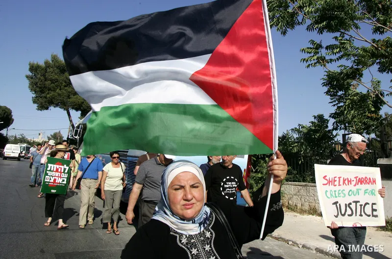 Palestinian demonstrators wave their national flag in the mostly Arab Jerusalem neighbourhood of Sheikh Jarrah on Jun 17, 2011 during a weekly demonstration by Israeli, Palestinian and international activists. Photo by M...