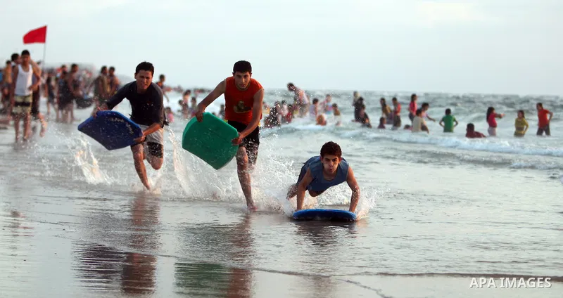 Palestinians bathing in the sea off on a beach in the west of Gaza City 17 June 2011. Reports state that during the summer the beach is a major venue for entertainment and leisure in the Gaza Strip.. Photo by Ali Jadalla...