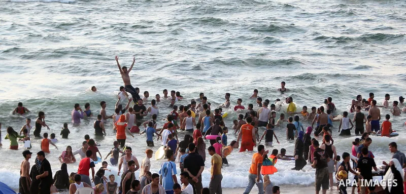 Palestinians bathing in the sea off on a beach in the west of Gaza City 17 June 2011. Reports state that during the summer the beach is a major venue for entertainment and leisure in the Gaza Strip.. Photo by Ali Jadalla...