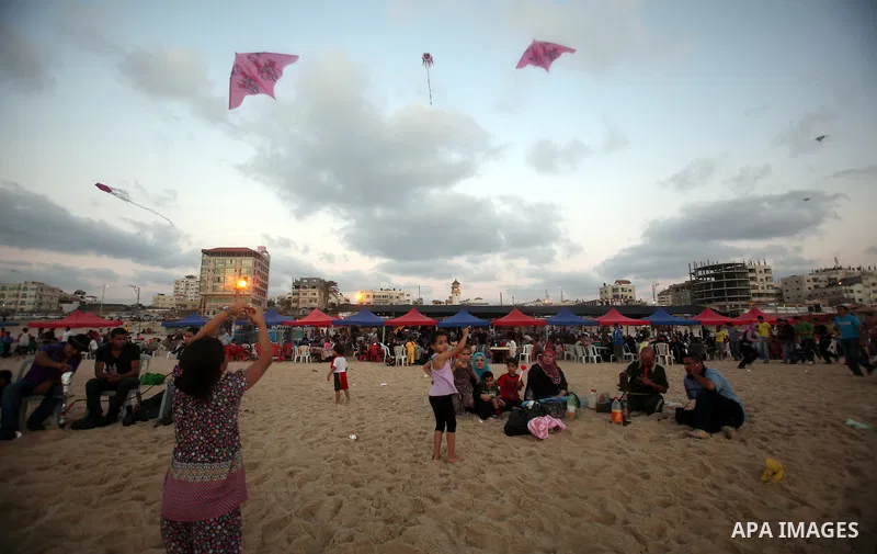 Palestinians fly kites on a beach in the west of Gaza City 17 June 2011. Reports state that during the summer the beach is a major venue for entertainment and leisure in the Gaza Strip. Photo by Ali Jadallah
