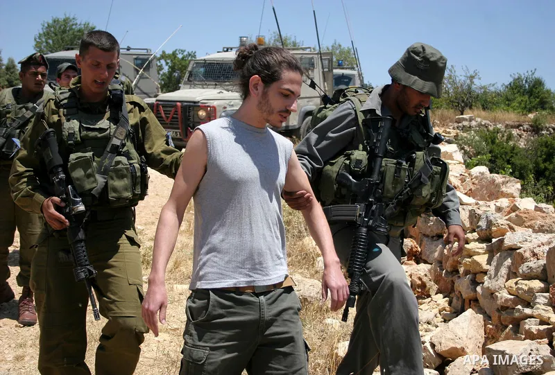 Israeli soldiers detain a foreign activist on Jun 18,2011 during a protest by foreign, Israeli and Palestinian activists against the Jewish settlement of Karmei Tzur near the Palestinian village of Beit Omar, just north...