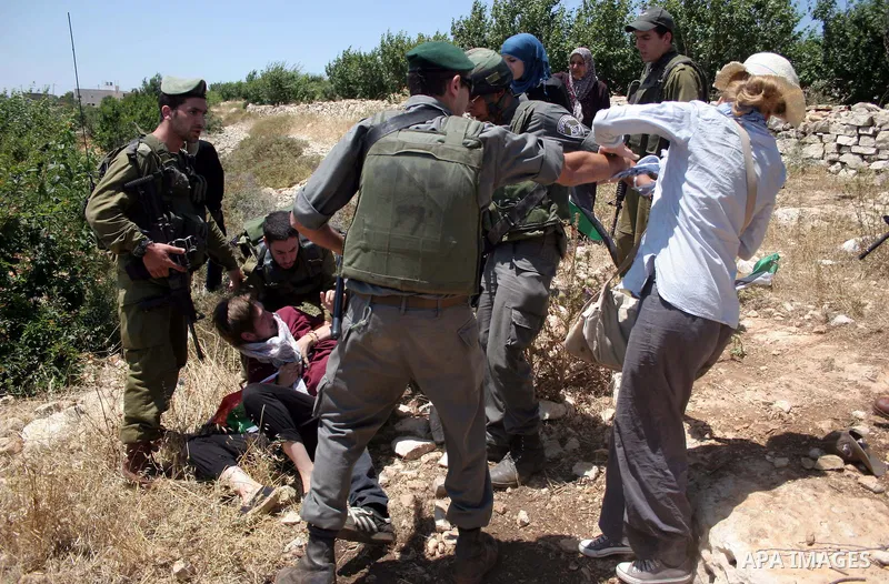Israeli soldiers scuffle with protesters on Jun 18, 2011 during a demonstration by foreign, Israeli and Palestinian activists against the Jewish settlement of Karmei Tzur near the Palestinian village of Beit Omar, just n...
