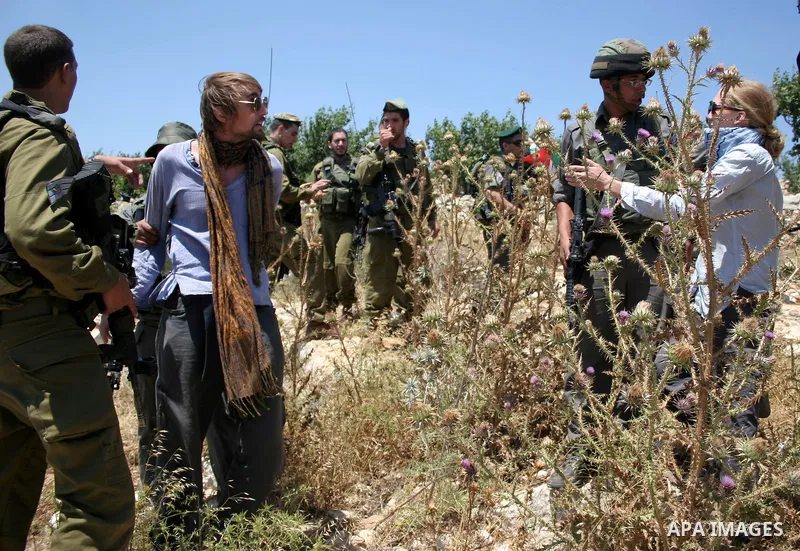 Israeli soldiers detain a foreign activist on Jun 18,2011 during a protest by foreign, Israeli and Palestinian activists against the Jewish settlement of Karmei Tzur near the Palestinian village of Beit Omar, just north...
