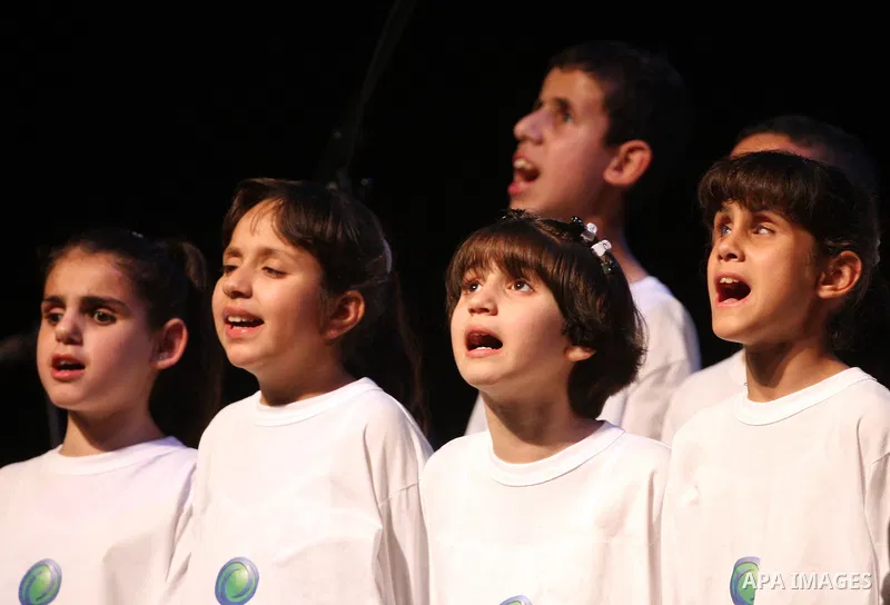 Blind Palestinian children sing and play on the musical instruments during a ceremony in the West Bank city of Ramallah on Jun 18,2011. Photo by Issam Rimawi