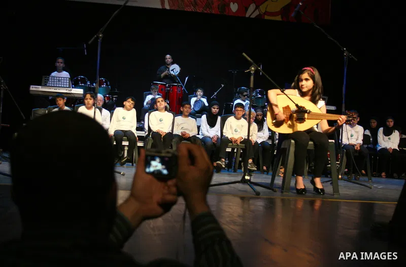 Blind Palestinian children sing and play on the musical instruments during a ceremony in the West Bank city of Ramallah on Jun 18,2011. Photo by Issam Rimawi