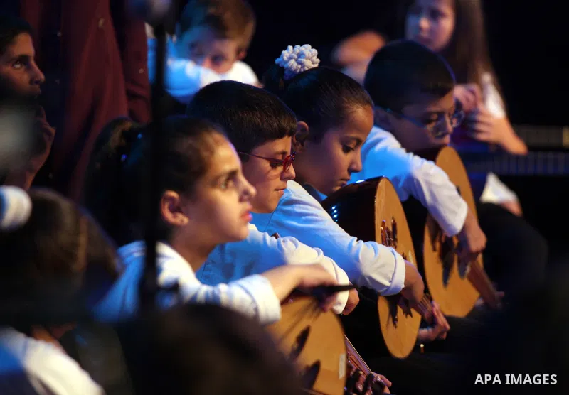 Blind Palestinian children sing and play on the musical instruments during a ceremony in the West Bank city of Ramallah on Jun 18,2011. Photo by Issam Rimawi