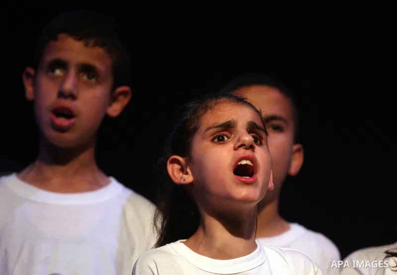 Blind Palestinian children sing and play on the musical instruments during a ceremony in the West Bank city of Ramallah on Jun 18,2011. Photo by Issam Rimawi