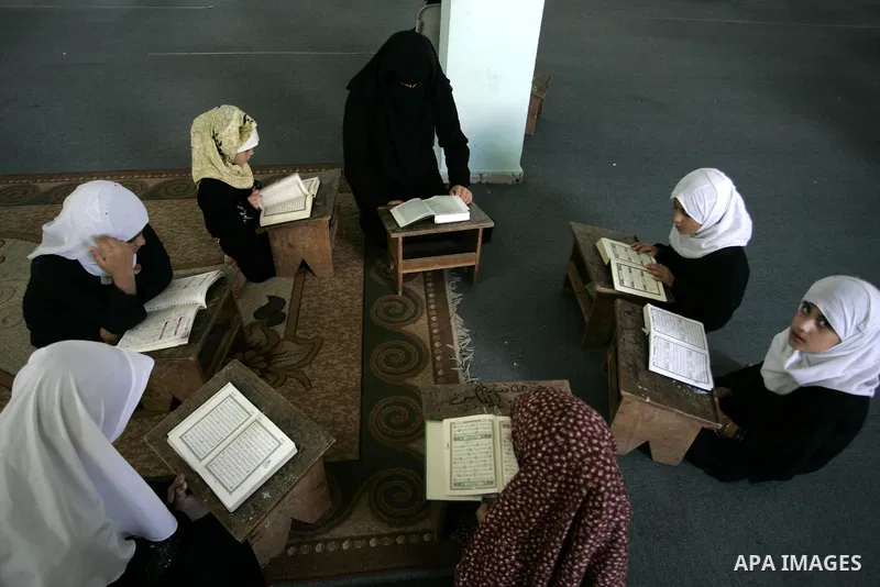 Palestinian girls read the Koran at a summer camp for the study of Islam's holy book organised by the Islamist movement Hamas in Rafah in the southern of Gaza Strip on June 19, 2011. Photo by Abed Rahim Khatib
