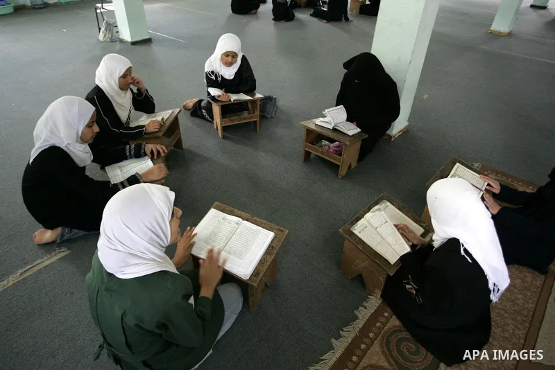 Palestinian girls read the Koran at a summer camp for the study of Islam's holy book organised by the Islamist movement Hamas in Rafah in the southern of Gaza Strip on June 19, 2011. Photo by Abed Rahim Khatib