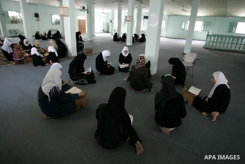 Palestinian girls read the Koran at a summer camp for the study of Islam's holy book organised by the Islamist movement Hamas in Rafah in the southern of Gaza Strip on June 19, 2011. Photo by Abed Rahim Khatib