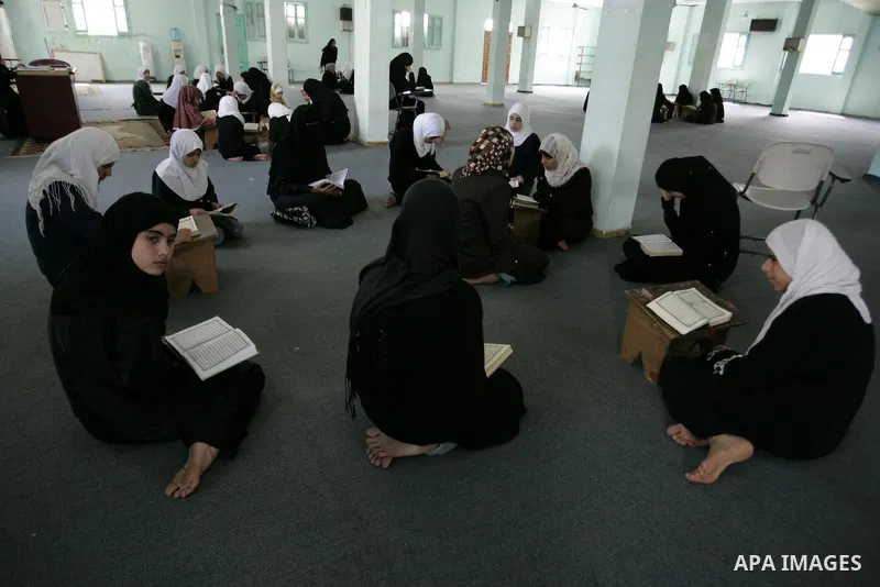 Palestinian girls read the Koran at a summer camp for the study of Islam's holy book organised by the Islamist movement Hamas in Rafah in the southern of Gaza Strip on June 19, 2011. Photo by Abed Rahim Khatib